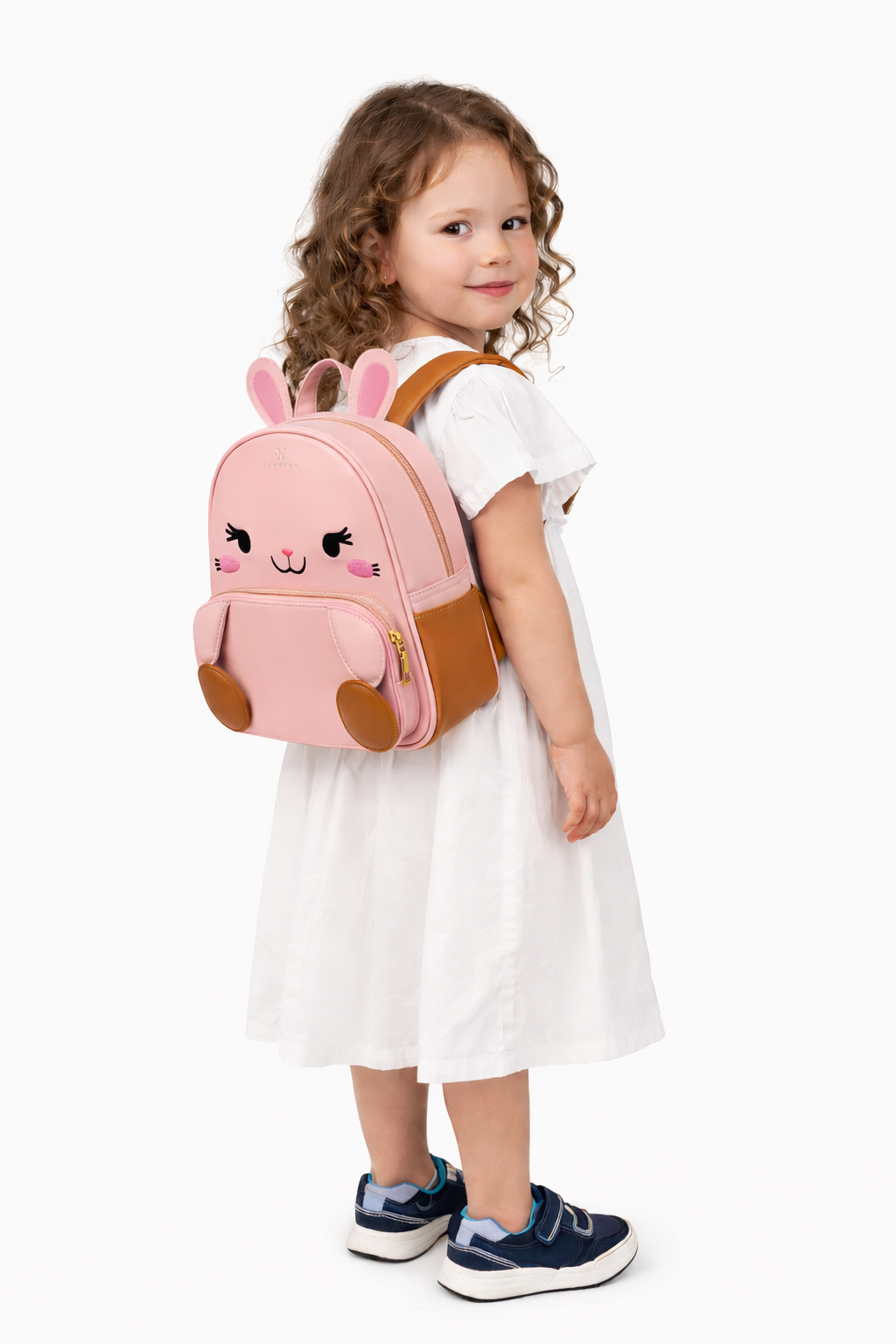 Child wearing a pink backpack with animal design on a white background