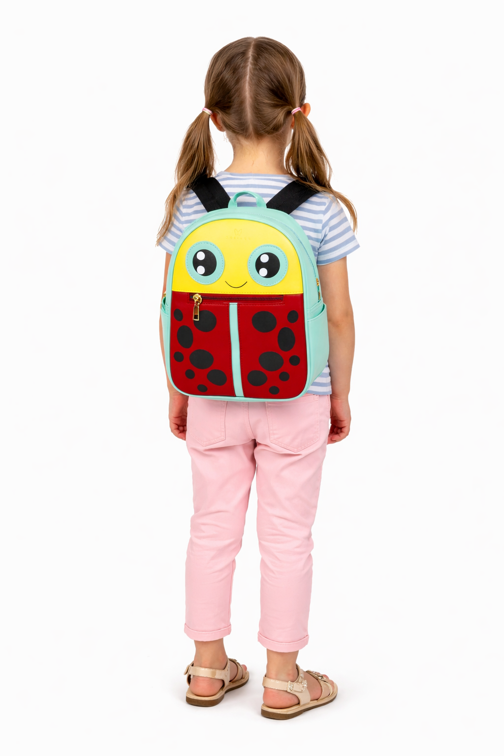 Child wearing a backpack with a ladybug design on a white background Katinka